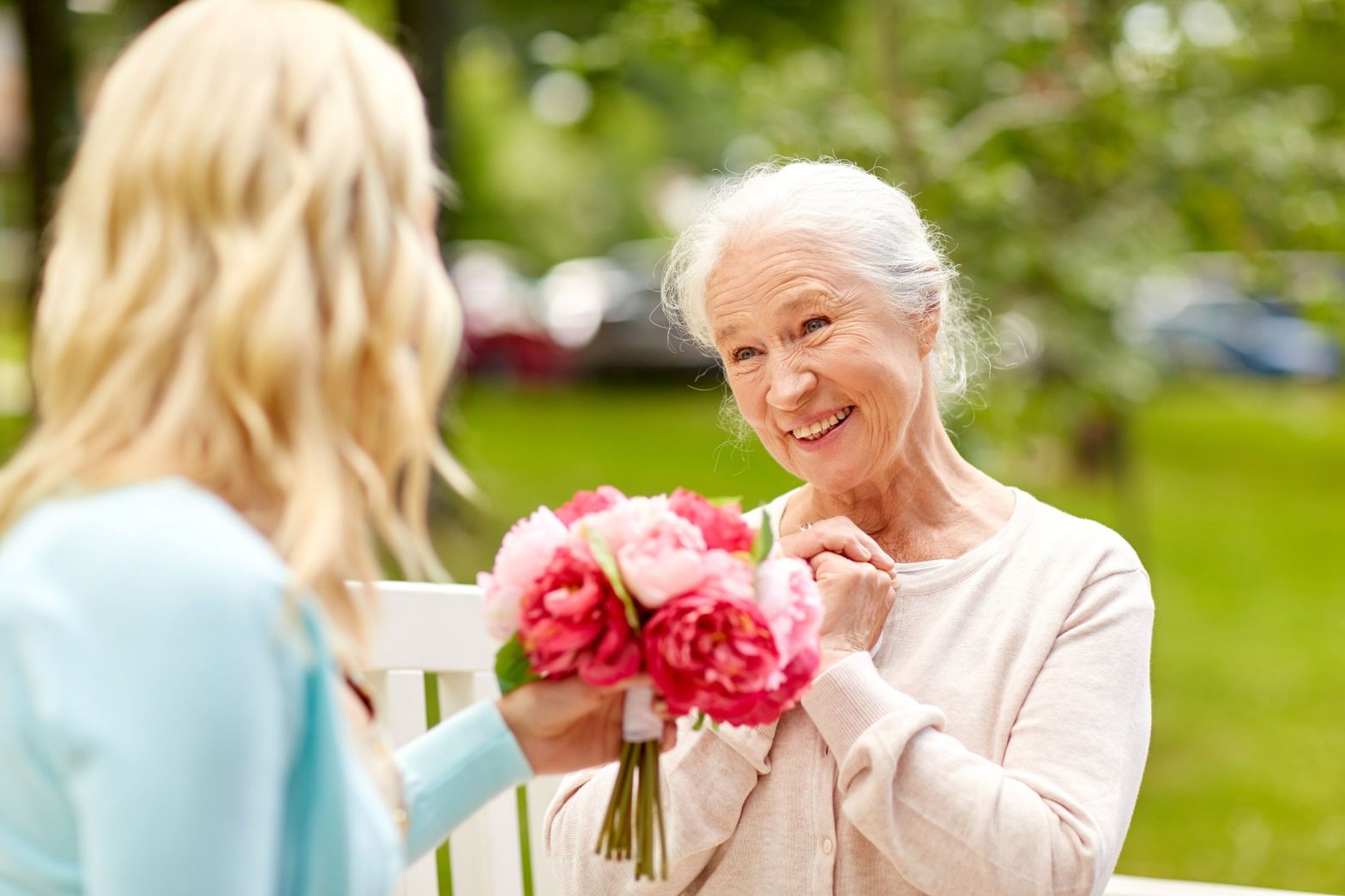 elderly woman receiving flowers