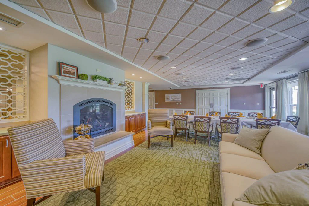 room with fireplace, chairs, tables, and a large couch