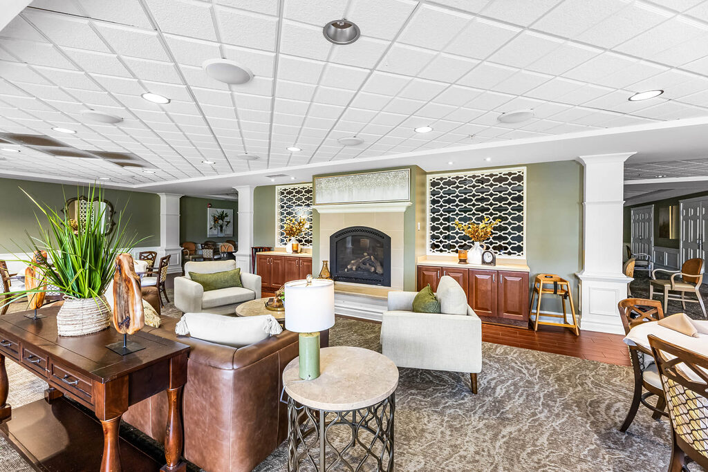 Cozy common area with modern decor and fireplace in a senior living community.